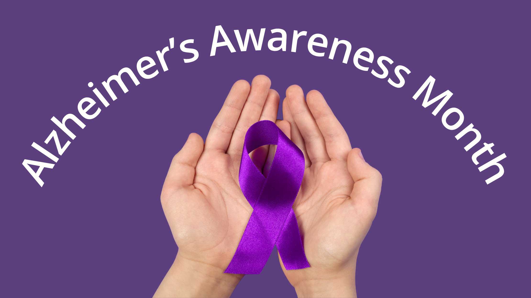 A pair of hands holding an Alzheimer's Awareness purple ribbon