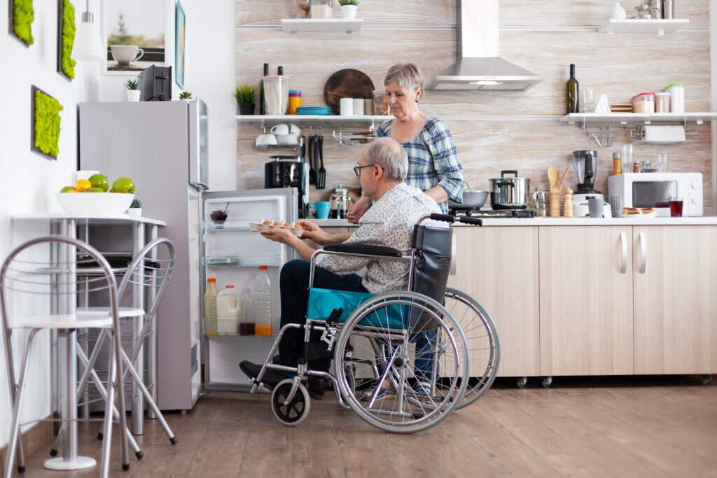 man in a wheelchair receives care in his home thanks to attendance allowance payments