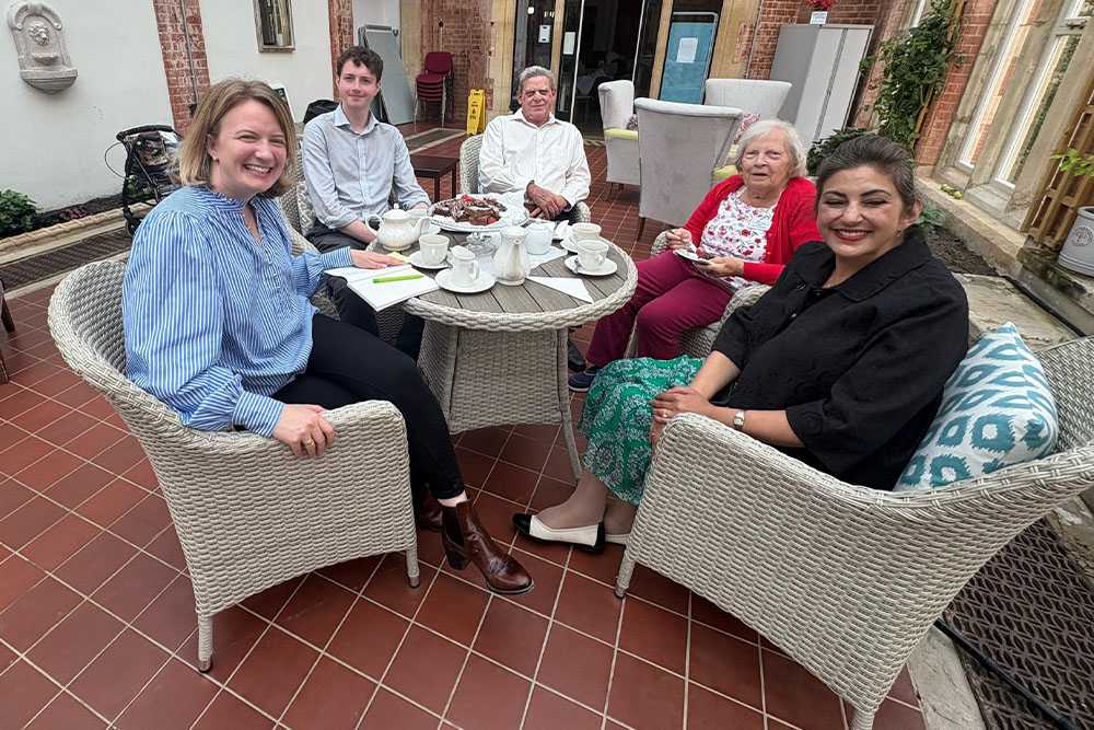 Iden Manor residents sitting at a table smiling