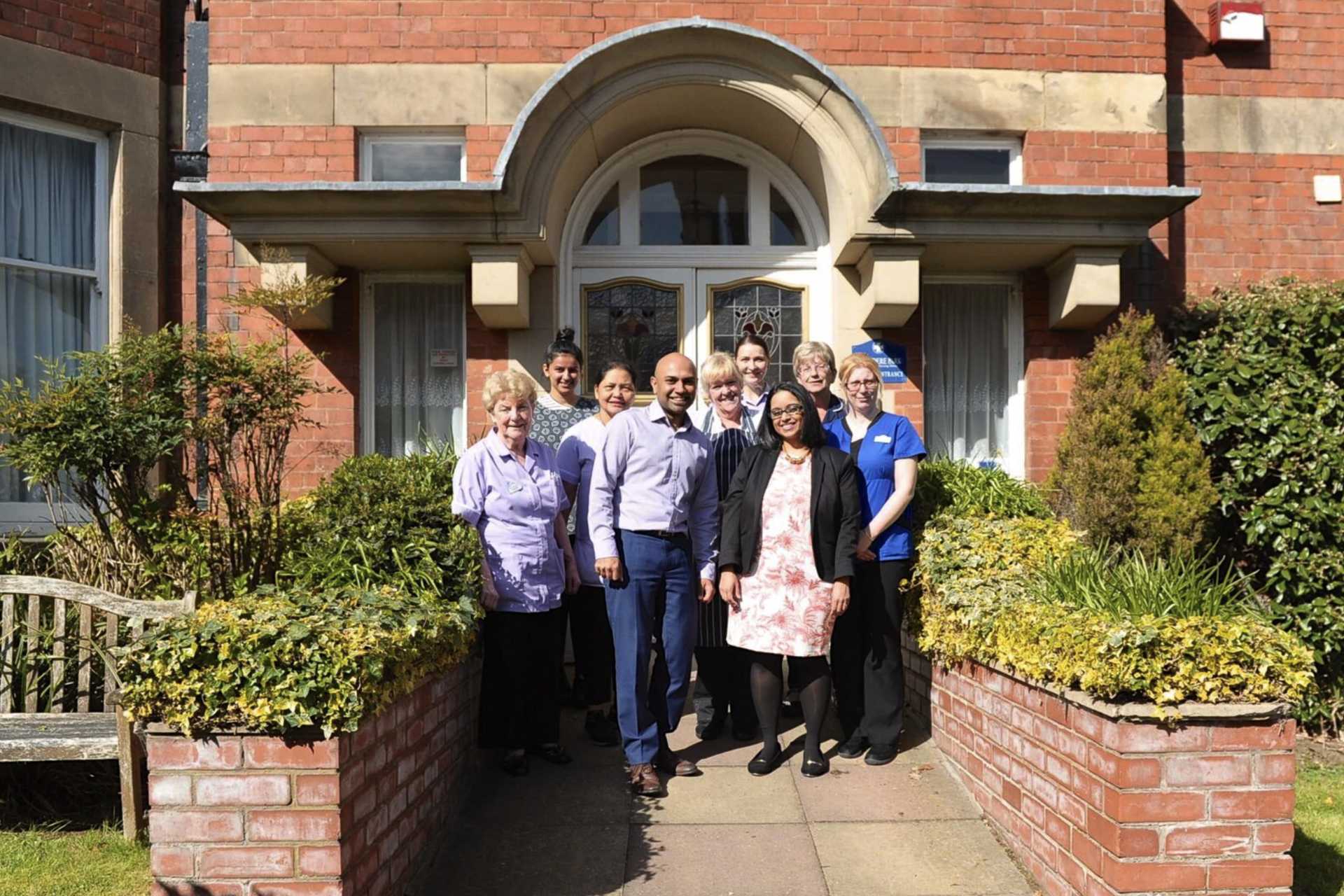 The management and care team standing at the entrance to Belvedere Park Nursing Home