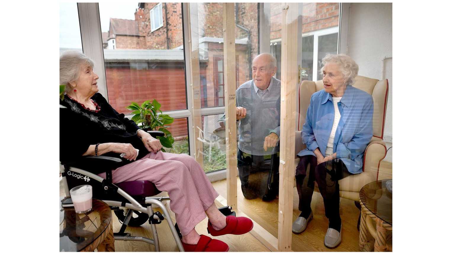 Manchester Evening News photo of people in a care home safe visiting space