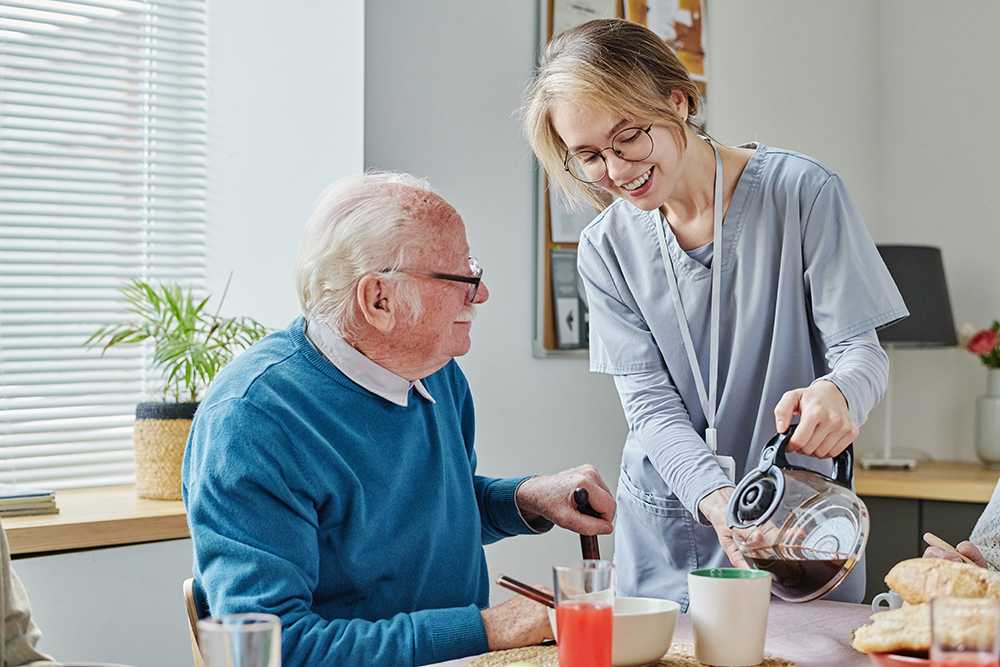 Woman pouring coffee for elderly man. What is live in home care