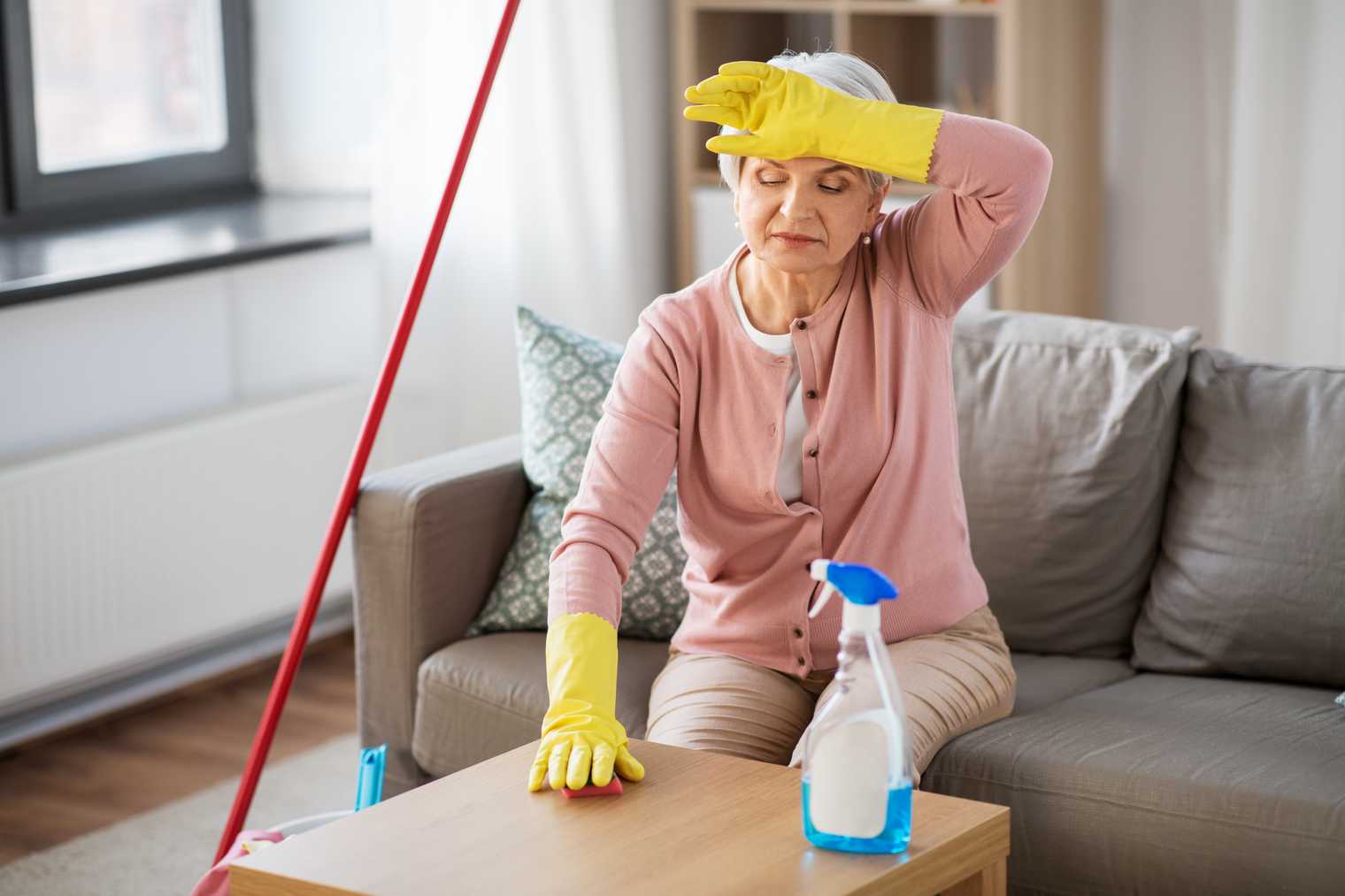 older woman cleaning her home and struggling without home care