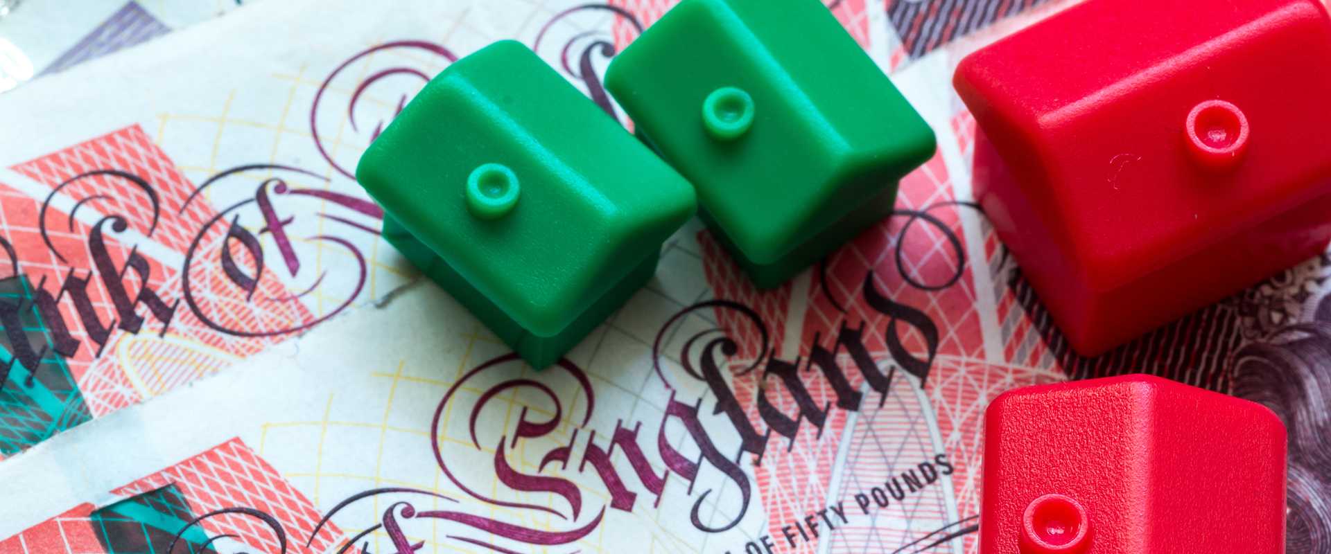 Monopoly board houses on English bank note