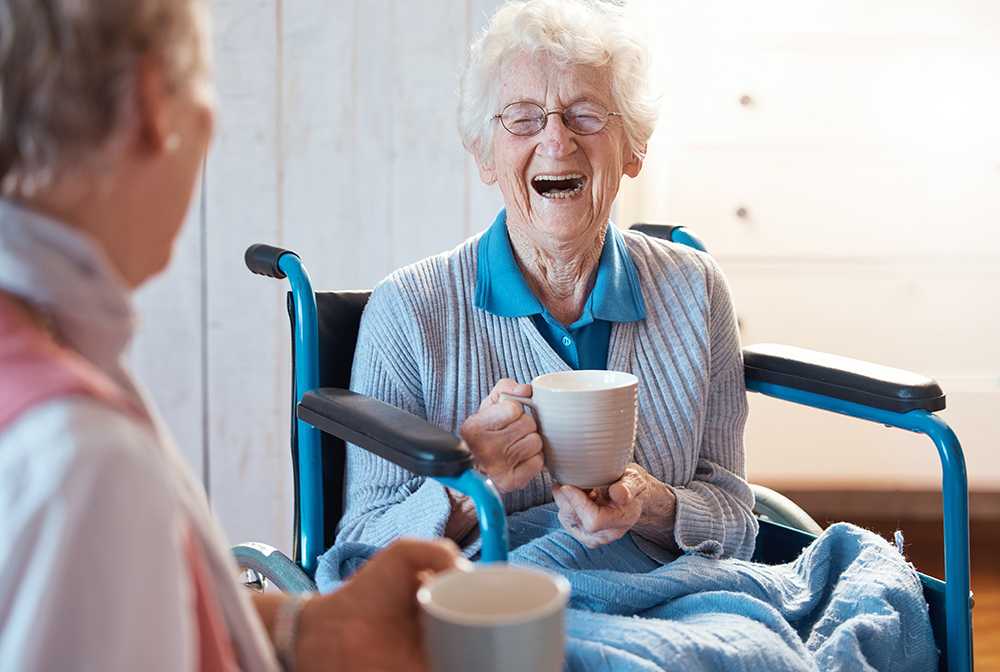 What is residential care. Elderly lady in wheelchair speaking to carer