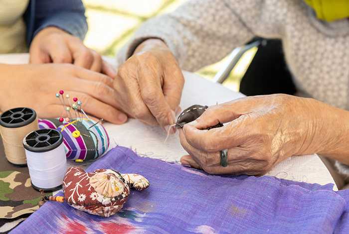Two elderly women doing arts and crafts