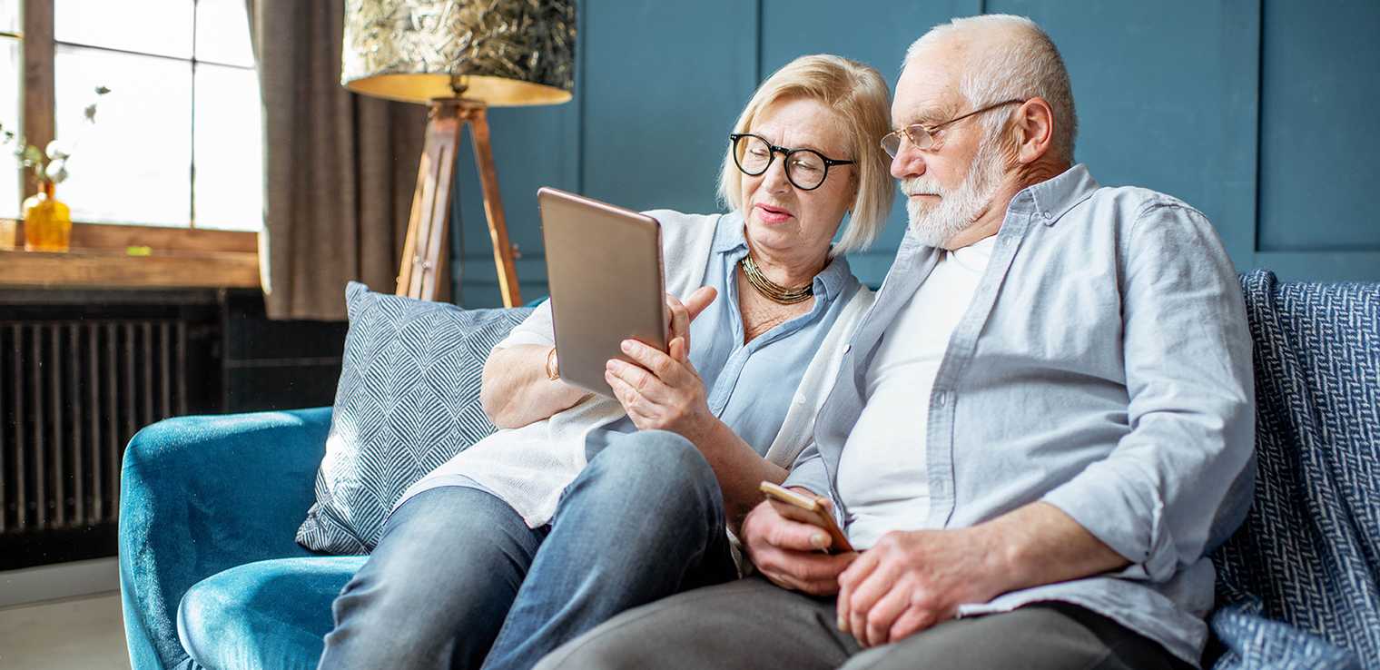 A senior couple using a digital tablet in a retirement home
