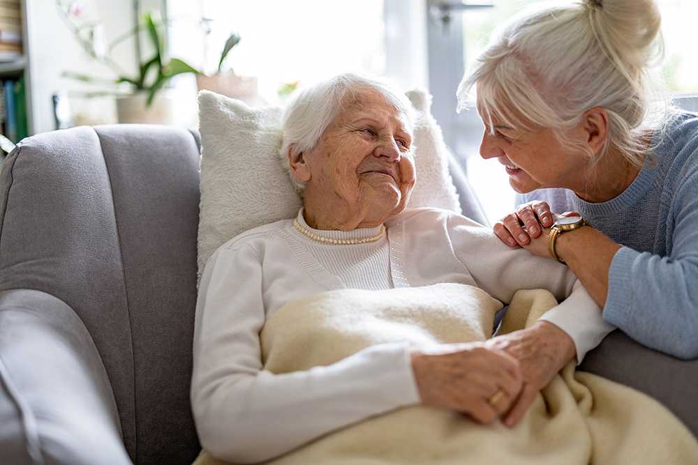Elderly man looking for a new nursing home on blank laptop