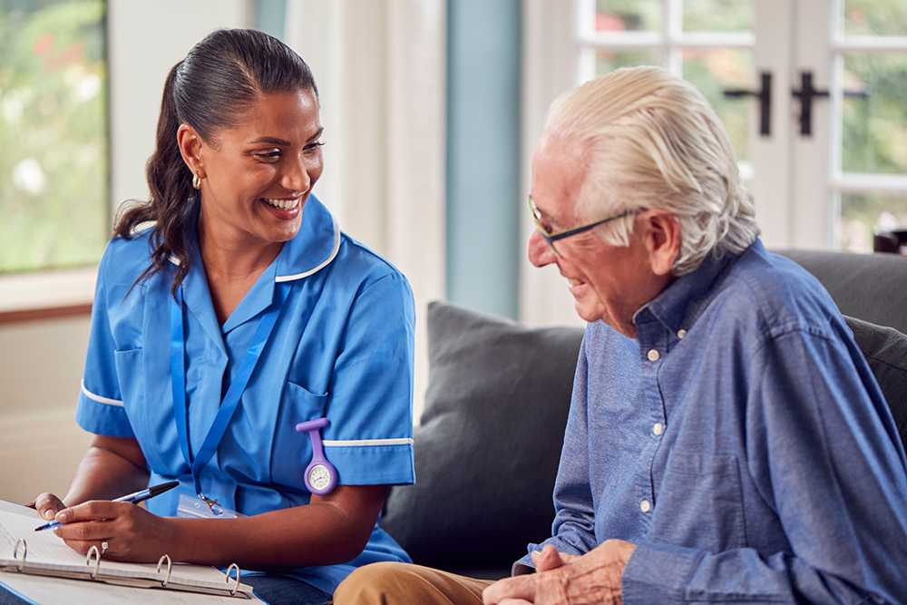 What is a care act assessment? Nurse in blue medical uniform with clipboard talking to elderly man