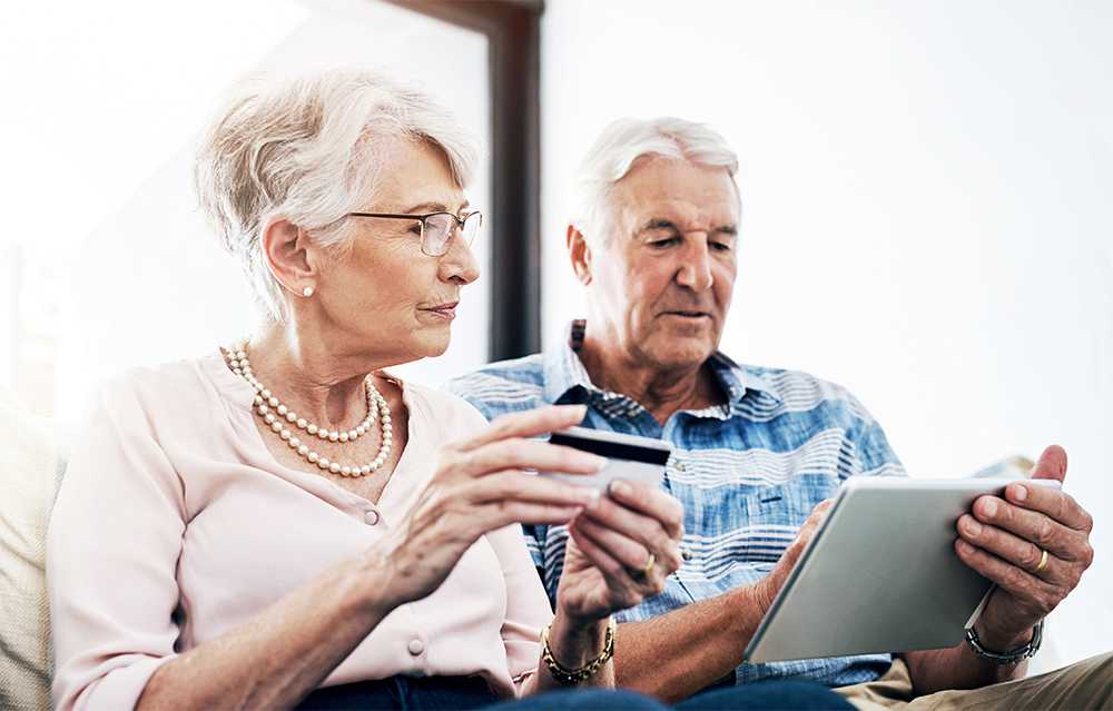 Senior couple checking out pension credit news