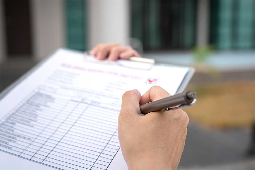 A woman holding a clipboard as we pose the question 'is the CQC failing care homes?'