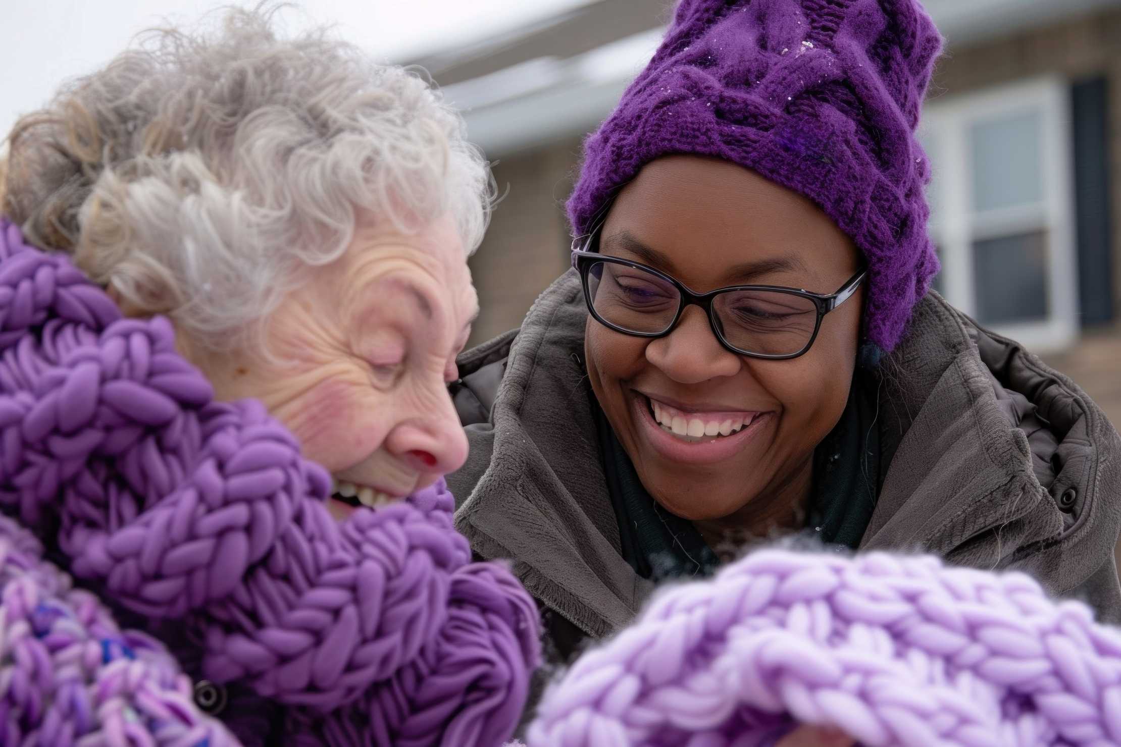 Elderly lady and black lady outside in purple