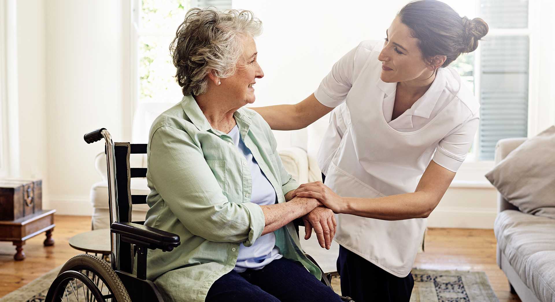 Live-in carer attending to a senior lady