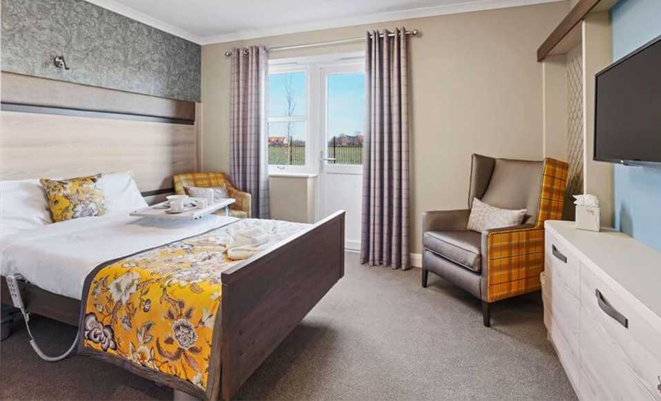 One of the bedrooms with patio access at Pear Tree House care home in Preston