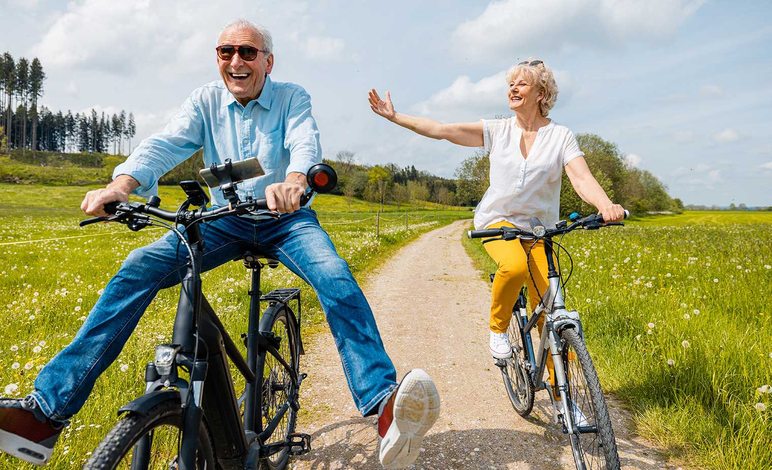 Happy senior couple on bicycles in the countryside