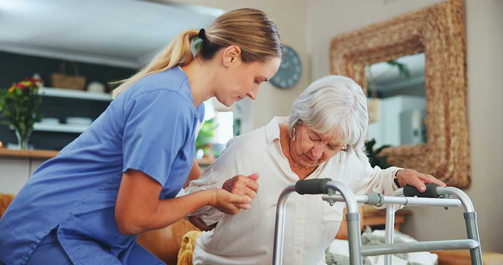 Convalescent care home nurse assisting with elderly woman