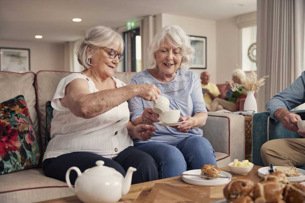 Two women sitting and drinking tea