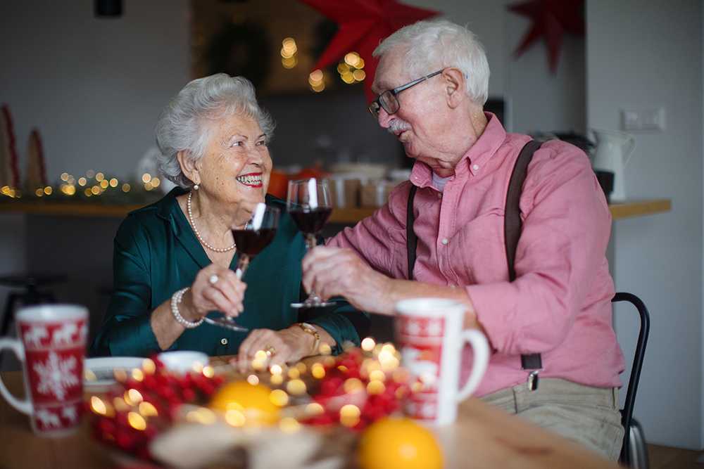 Elderly couple enjoying Christmas meals in care homes